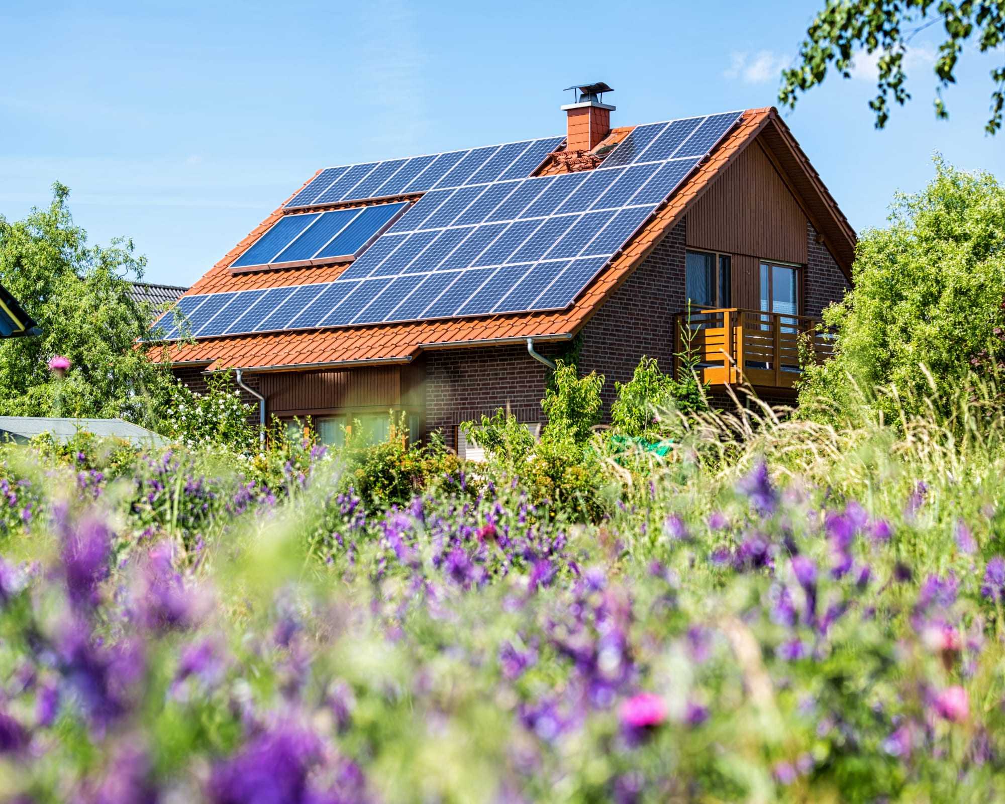 House in countryside with solar panels.
