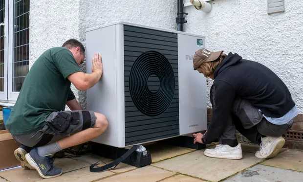 Energy efficiency installers installing an air source heat pump